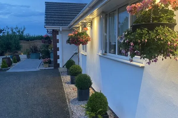 Outside Toppesfield House at evening with outside lights and hanging baskets