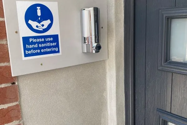 Hand sanitiser station outside an entrance to Toppesfield House